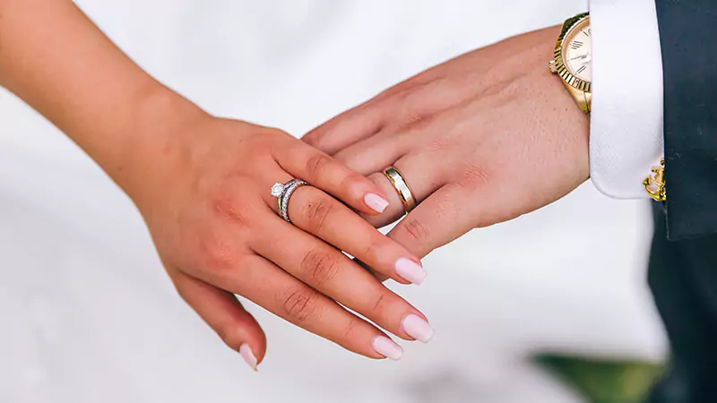 couple wearing their wedding rings