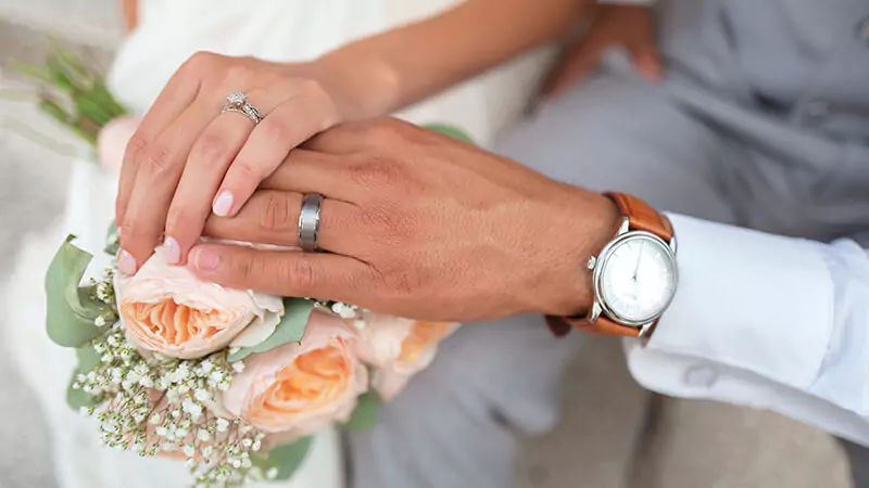 couple wearing their wedding rings