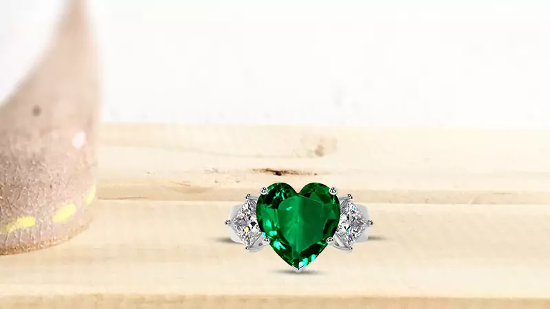 Heart-shaped emerald and princess cut diamond