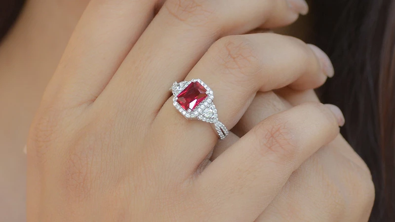a woman wearing a ruby wedding ring