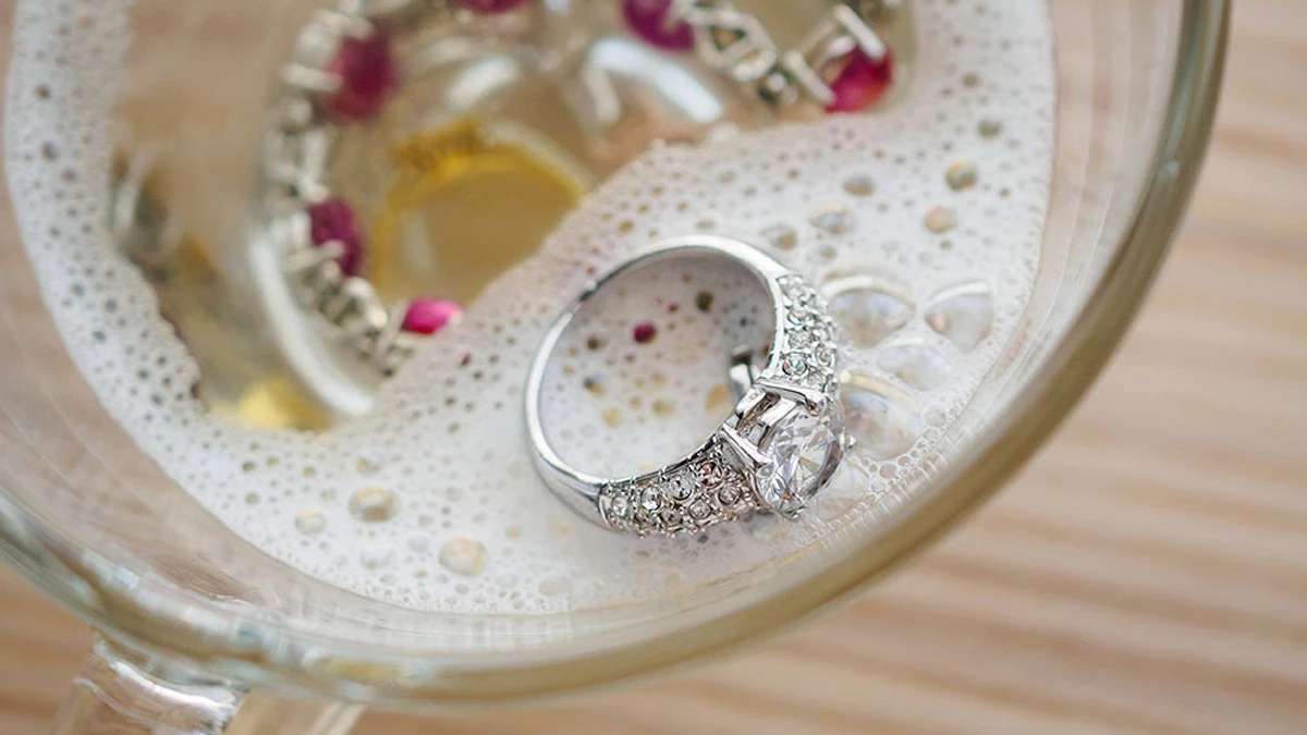 jewelry piece soaking in a solution of water and detergent