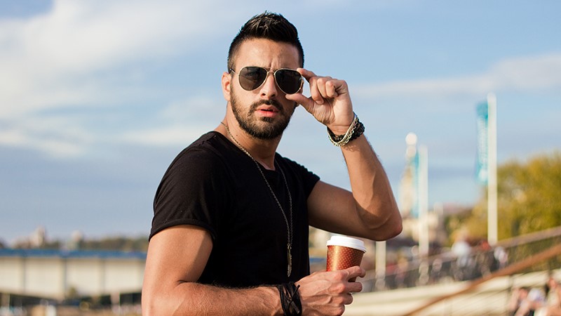 a man holding a sunglasses