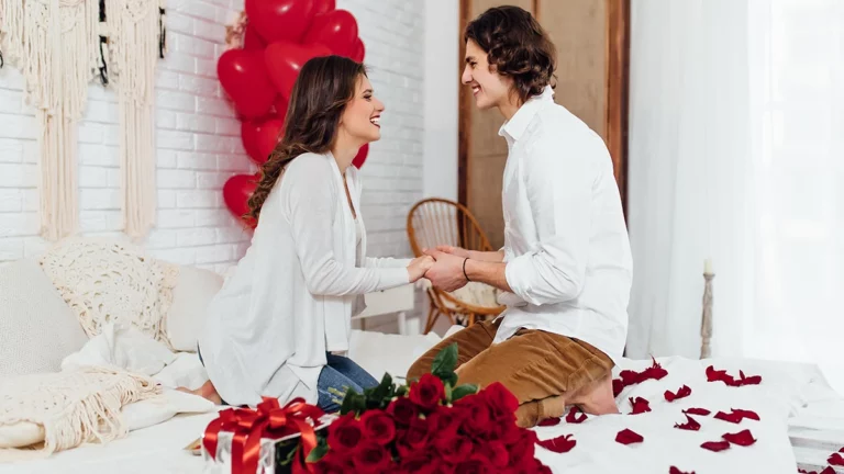 man proposing to woman with red bouquet